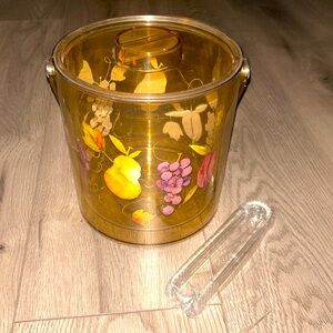 A vintage yellowish gold with flowers, fruit design, ice bucket